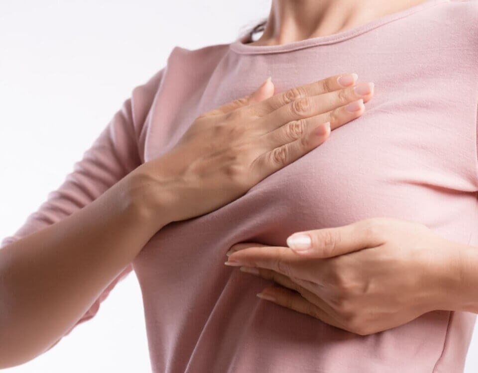 woman hand checking lumps her breast signs breast cancer resize